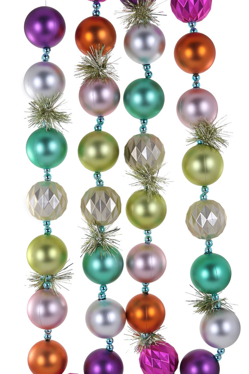 Tinsel garland with pastel rainbow baubles for Christmas decoration