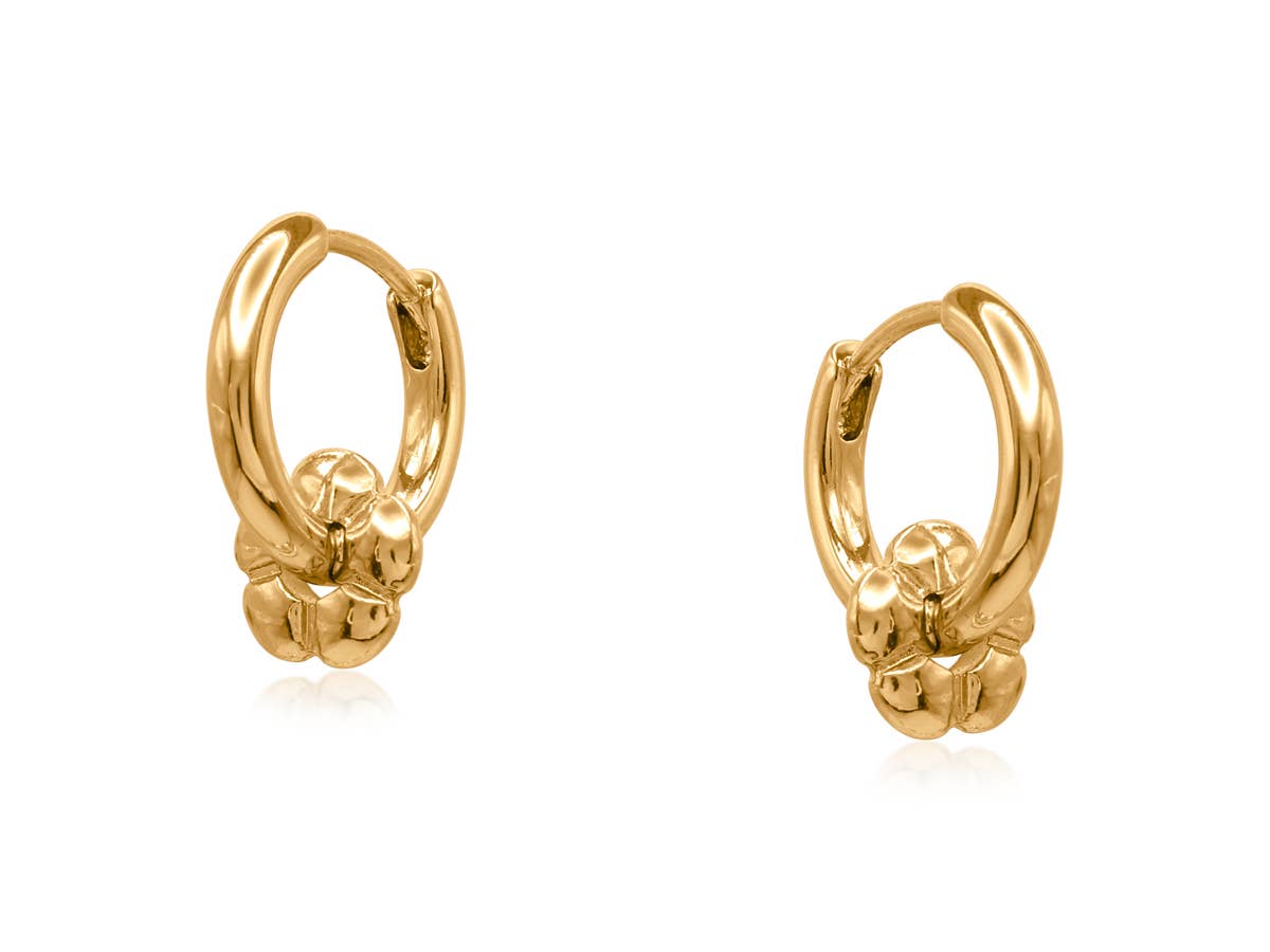 Gold Symbols of Power petite huggie earrings with a flower charm