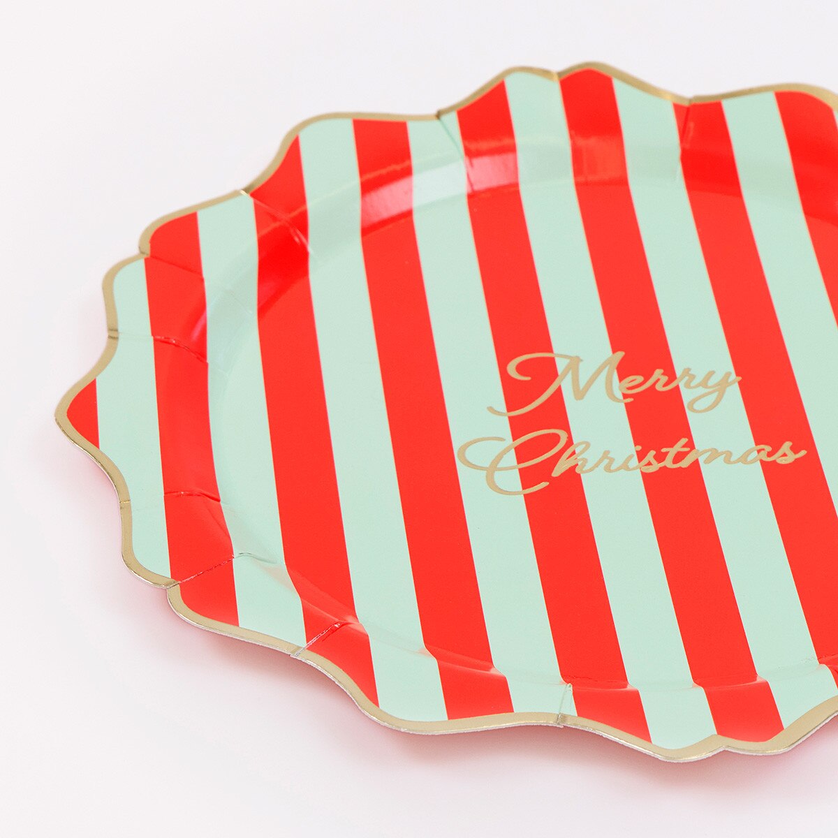Striped paper plates with a wavy gold foil edge
