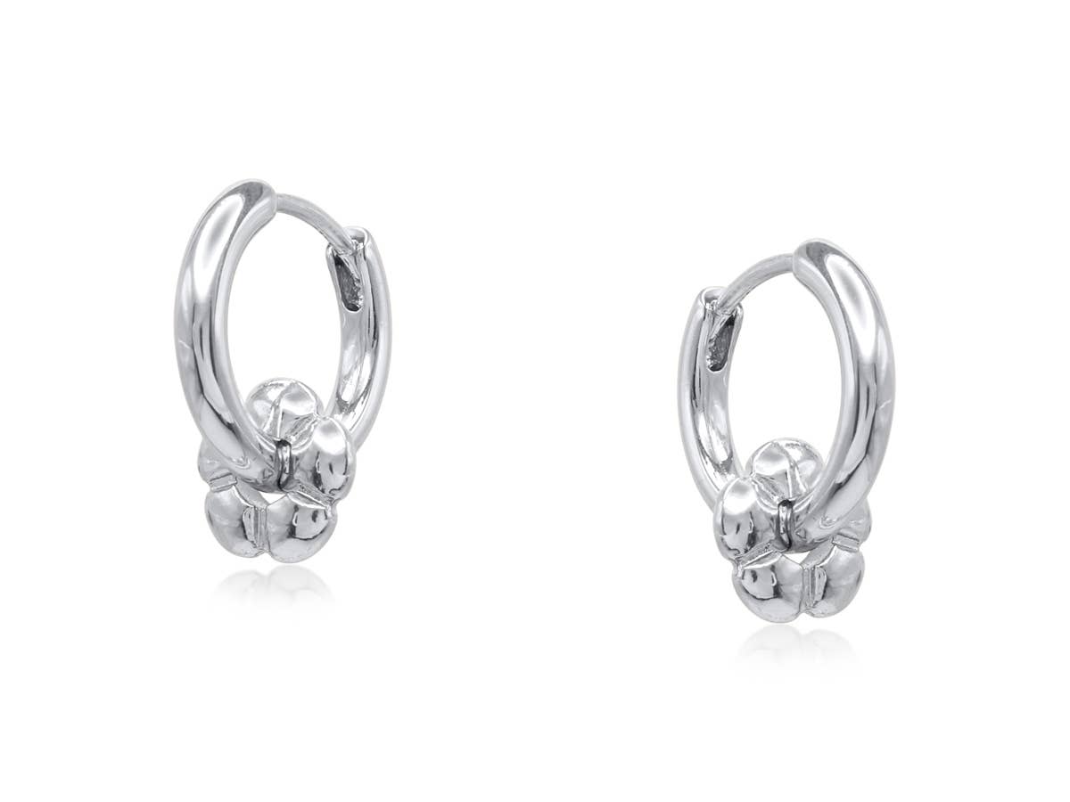 Silver Symbols of Power petite huggie earrings with a flower charm