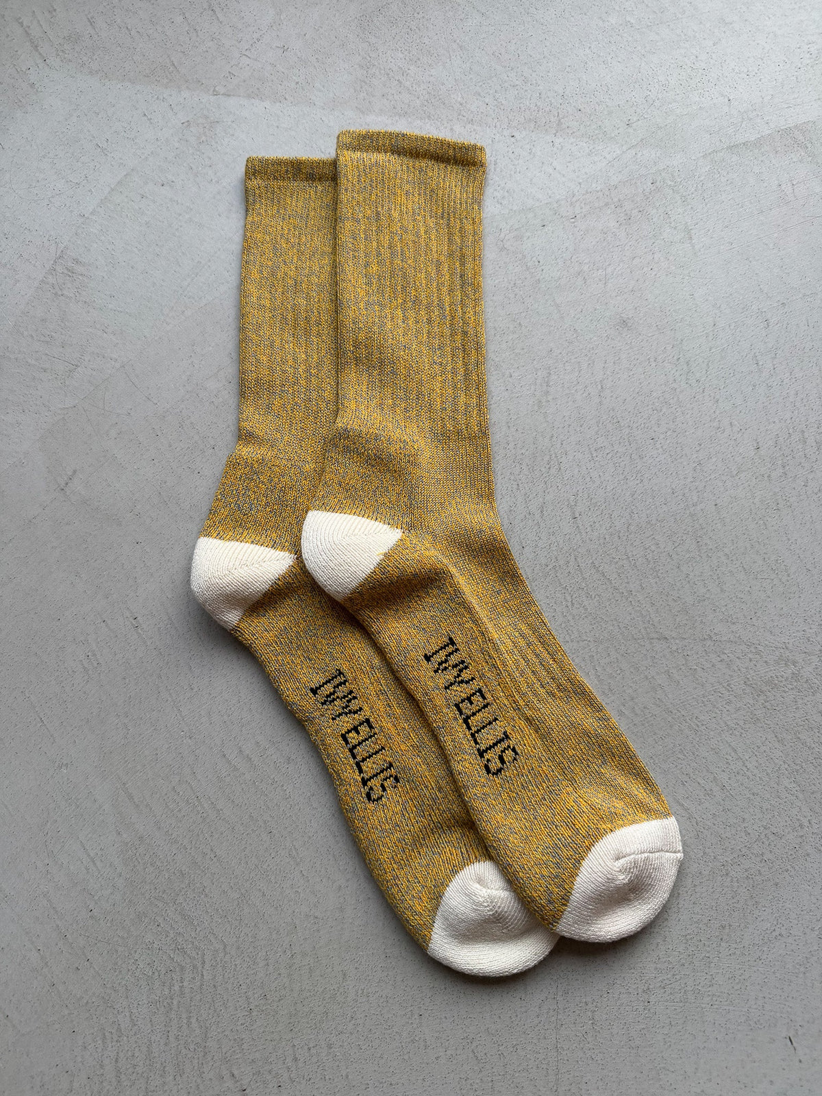 The Half Dome men's crew length socks by Ivy Ellis in mustard gold marl with a cream heel and toe