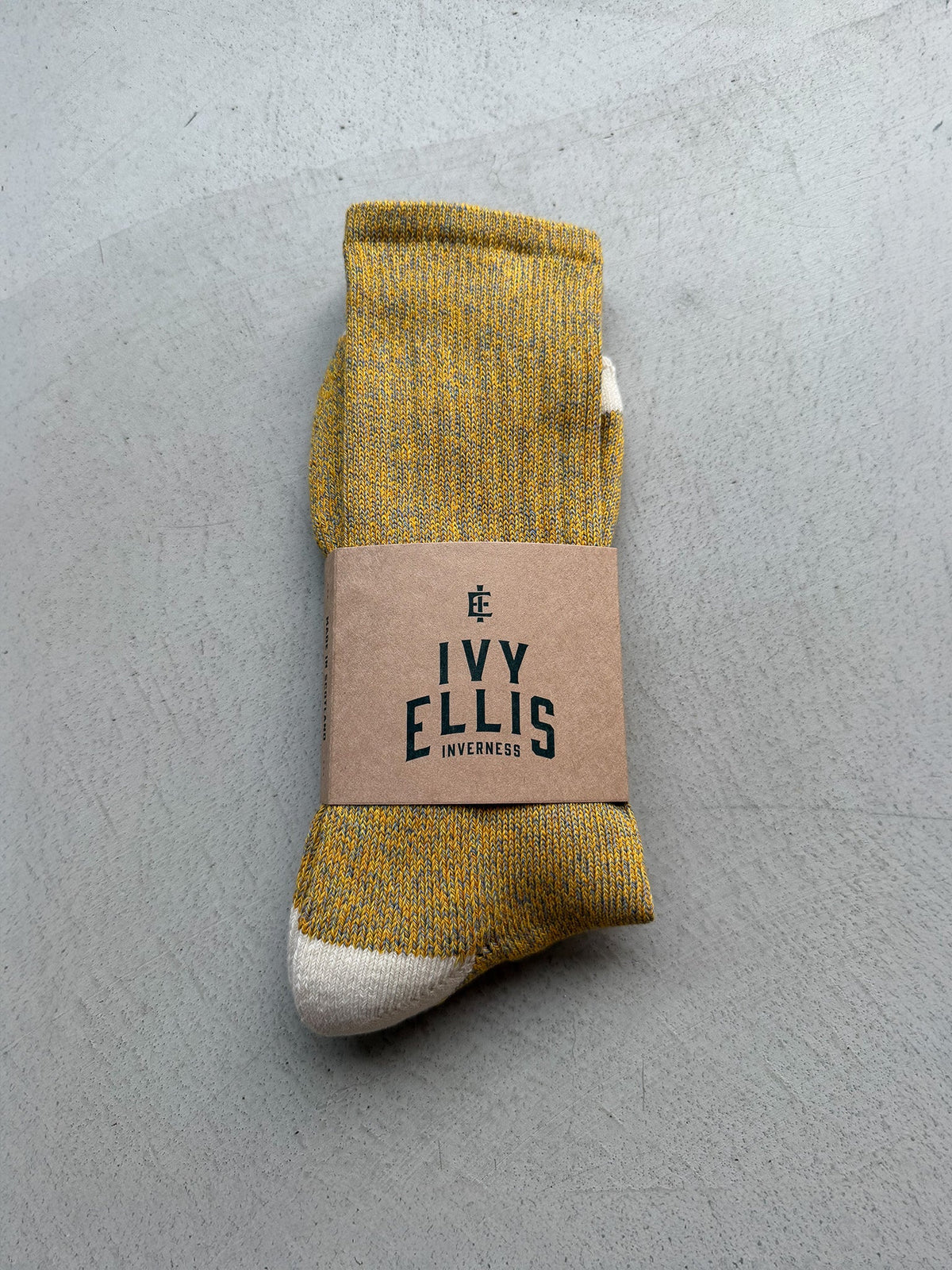 The Half Dome men's crew length socks by Ivy Ellis in mustard gold marl with a cream heel and toe