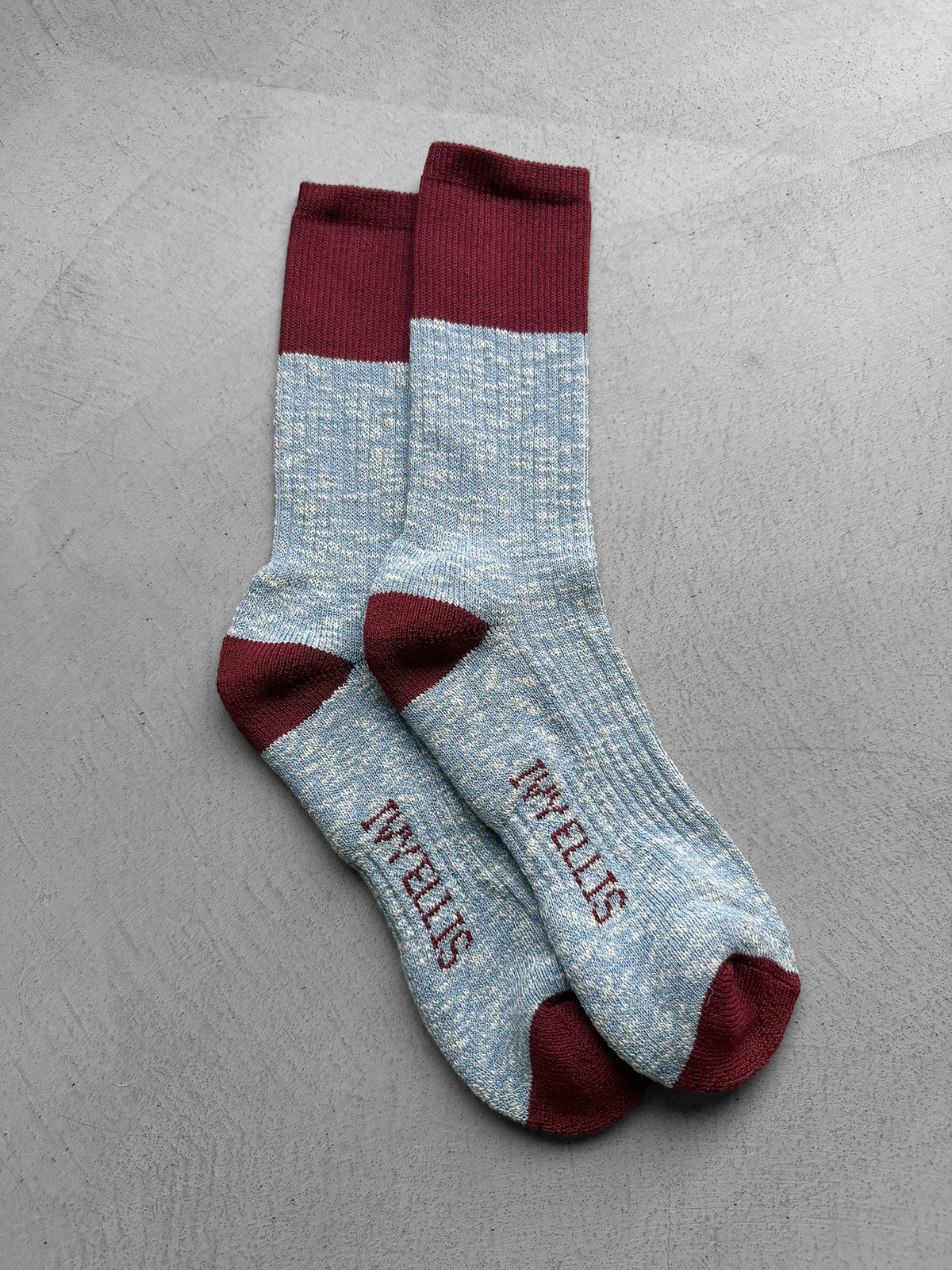 The Igor men's crew length socks by Ivy Ellis in blue slub with a burgundy accent