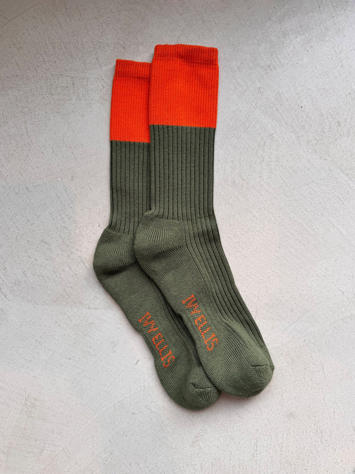 The Deerhunter men's crew length socks by Ivy Ellis in blaze orange and deep green